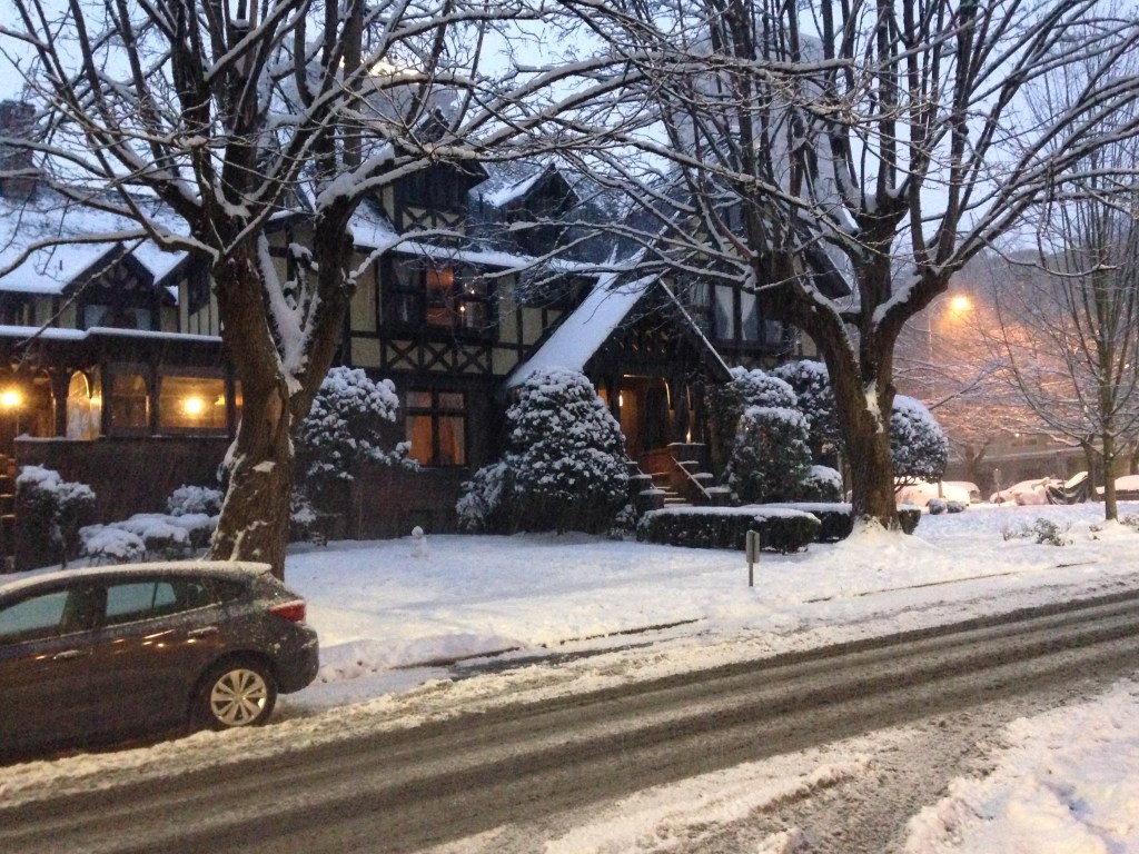 Tudor style mansion covered in snow. 