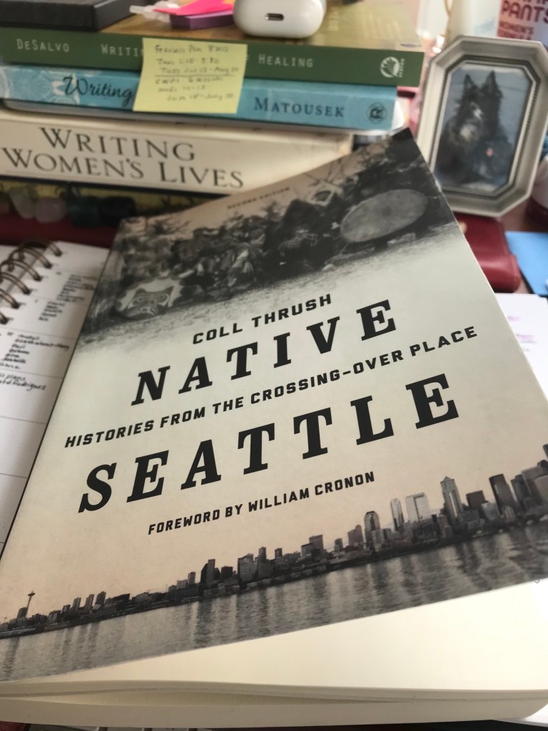Book with photo on cover of Native Americans above title and skyline of Seattle. 